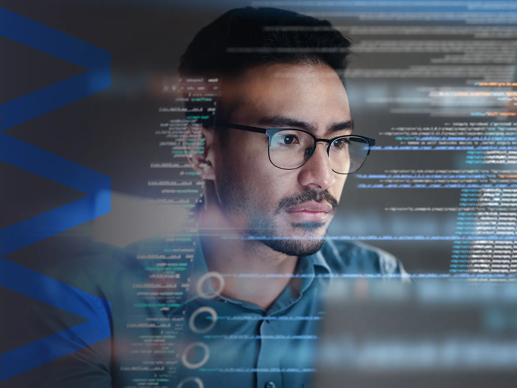 Male developer looking at coding overlaid with Modular Solutions