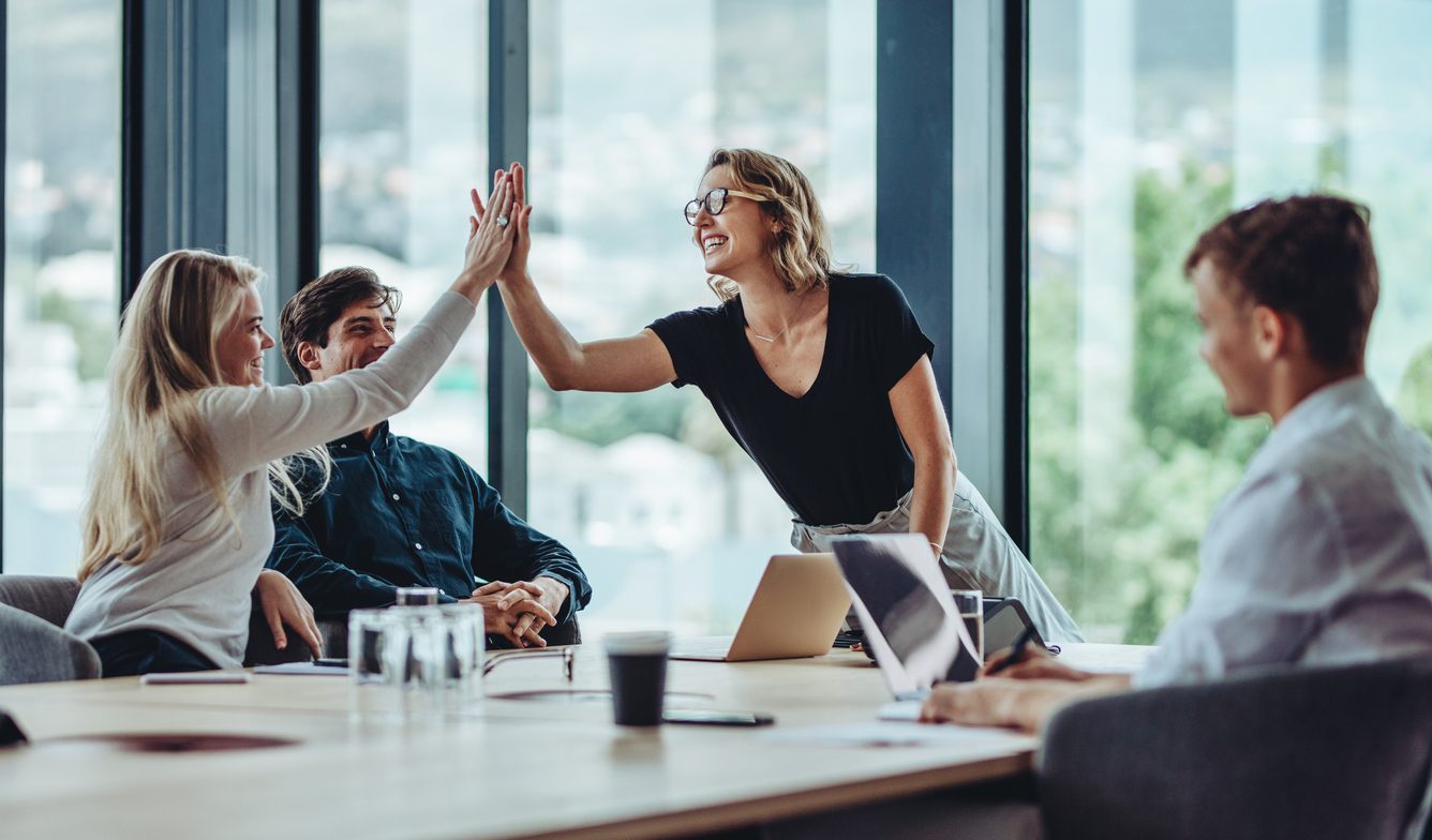 A group of colleagues celebrating with a high five