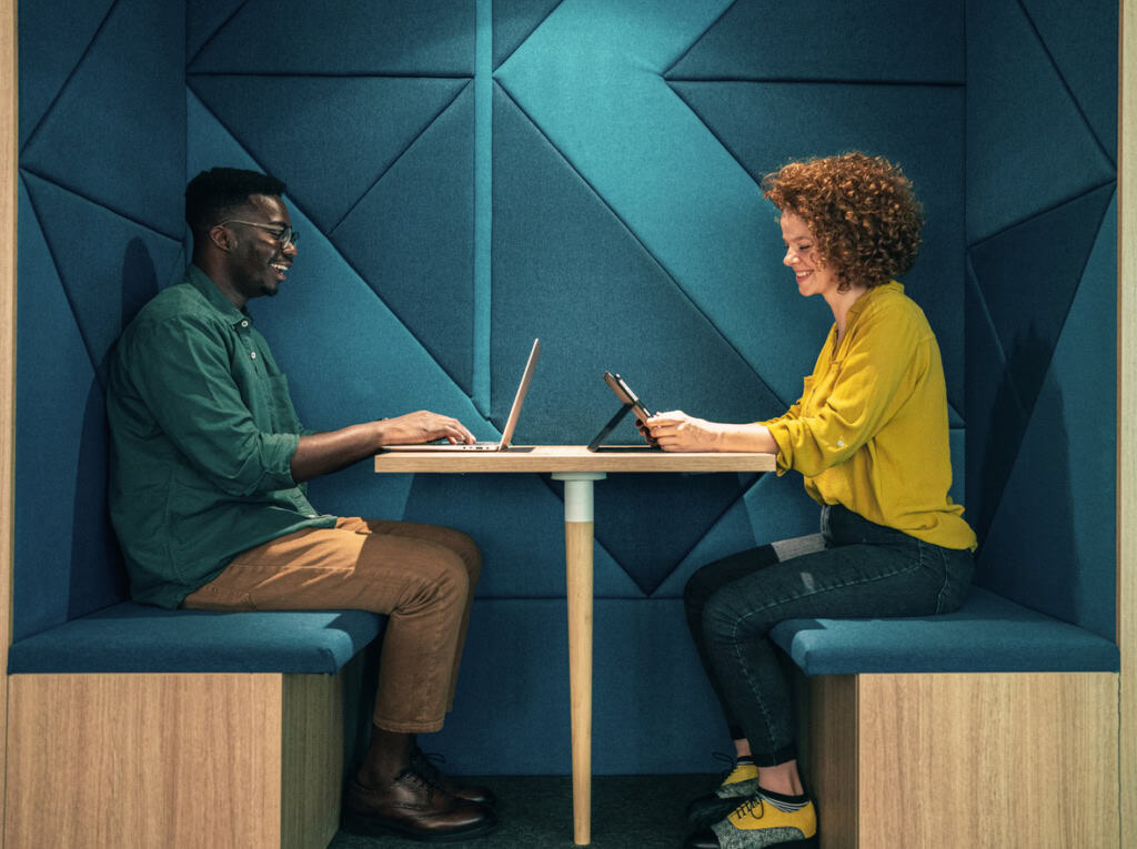 Two employees meeting in a modular desk
