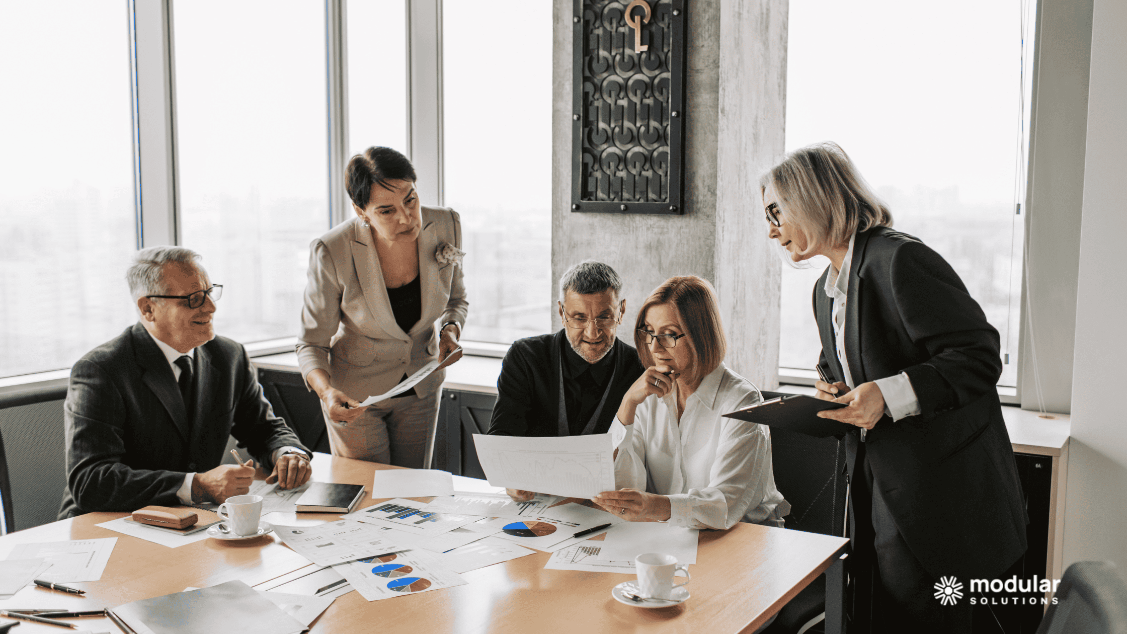Group of insurance executives discussing the ROI of automation