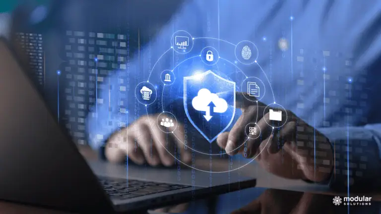 Employee working on a laptop with a new policy administration system with features