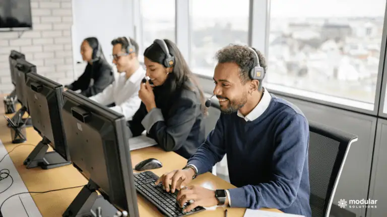 Insurance underwriters smiling as they use an effective policy administration system